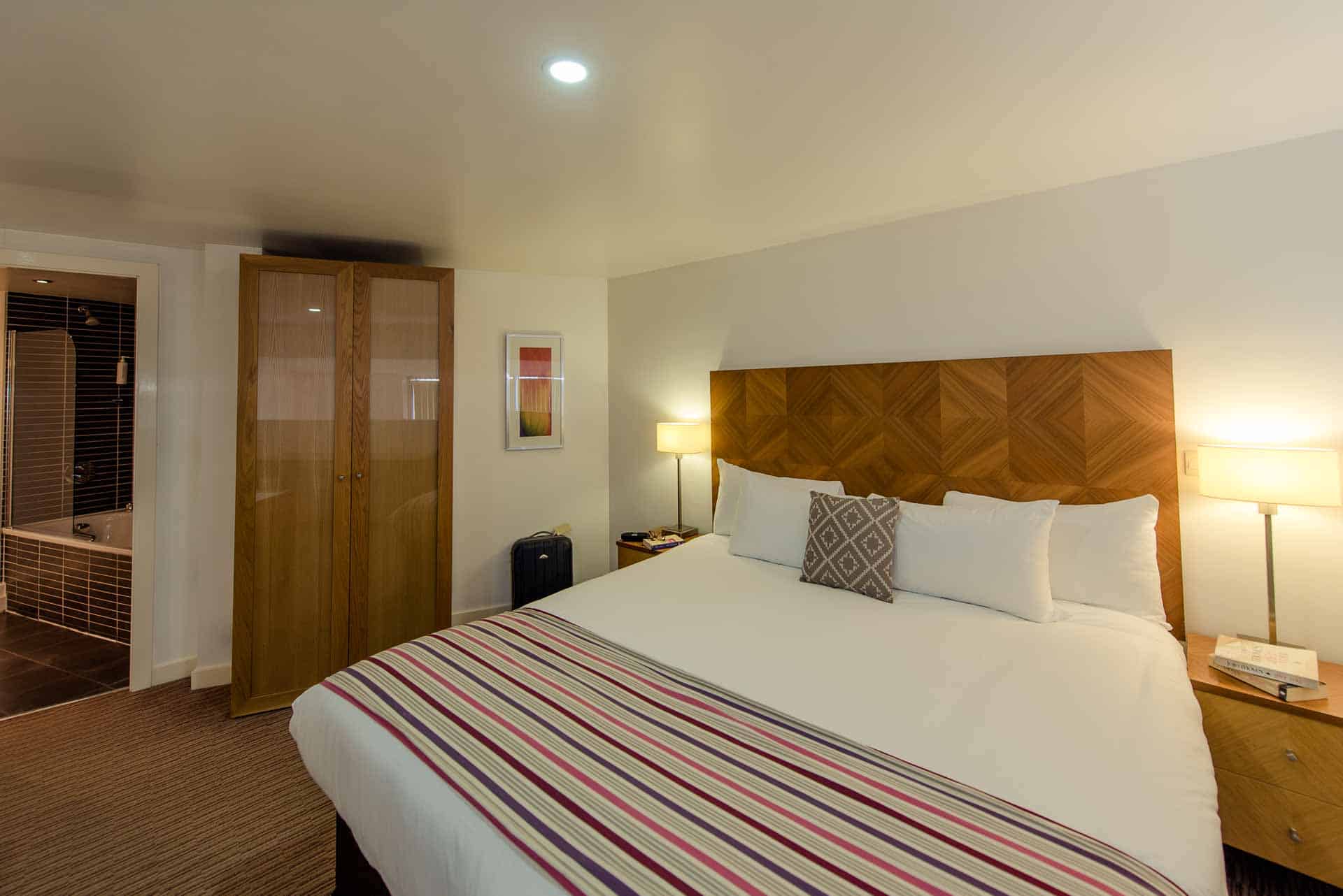Large bedroom at PREMIER SUITES Liverpool with comfortable bed, double wardrobe, ensuite and natural light