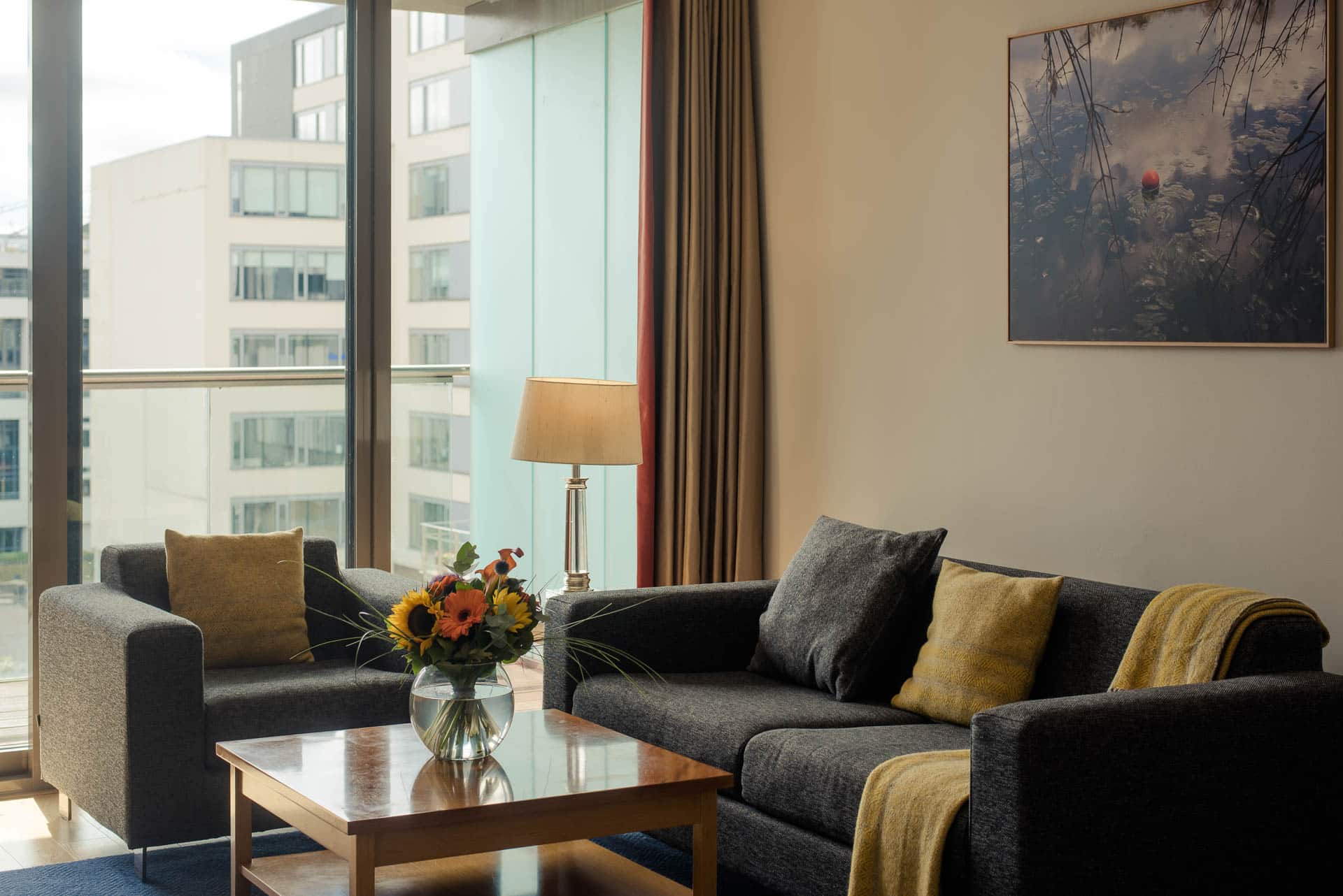 PREMIER SUITES Dublin Sandyford (living room sofa and window view)