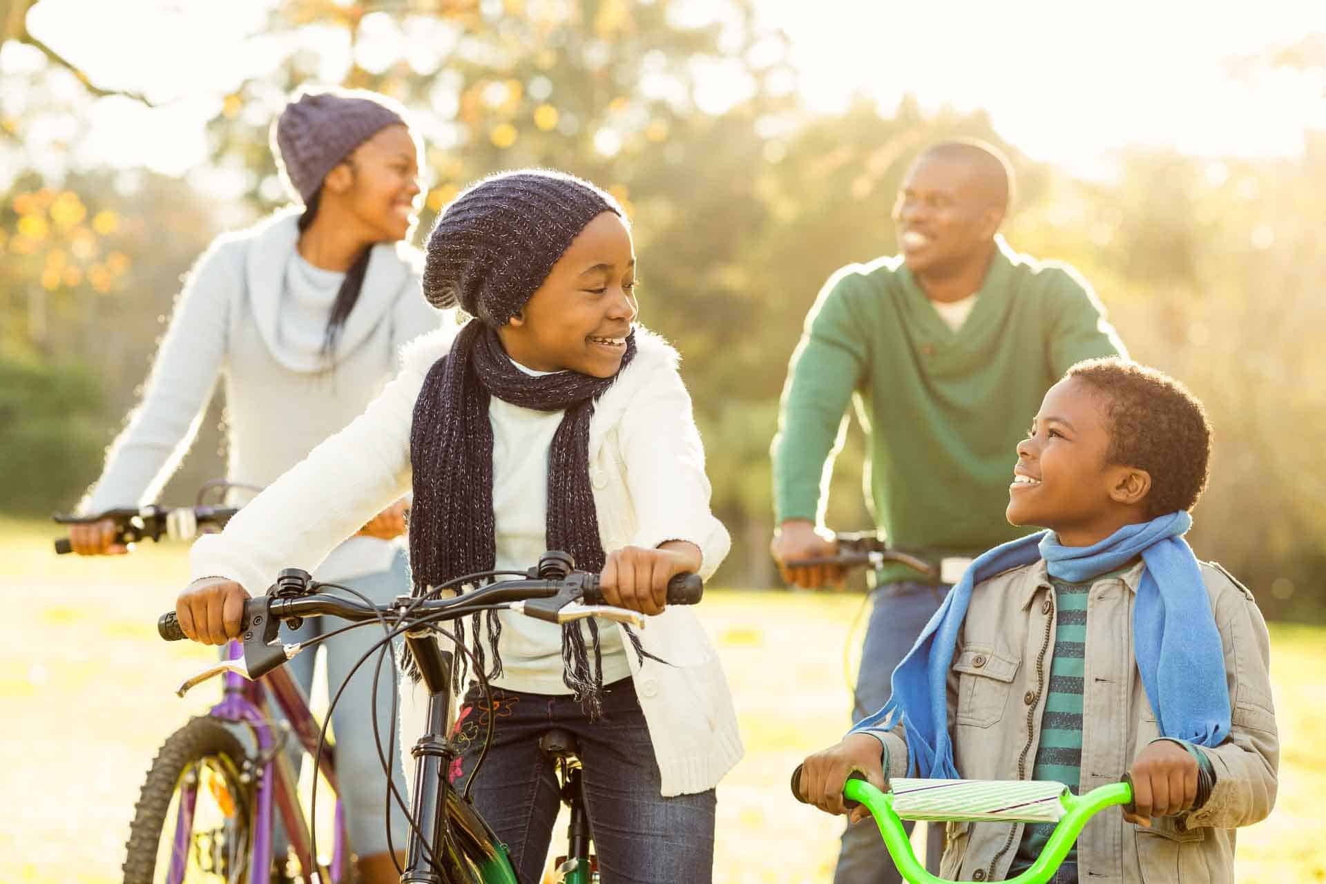 Young smiling family doing a bike ride on an autumns day