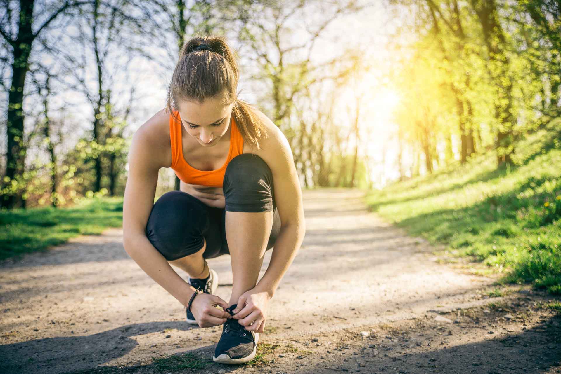 Young sportive woman getting ready to start running workout