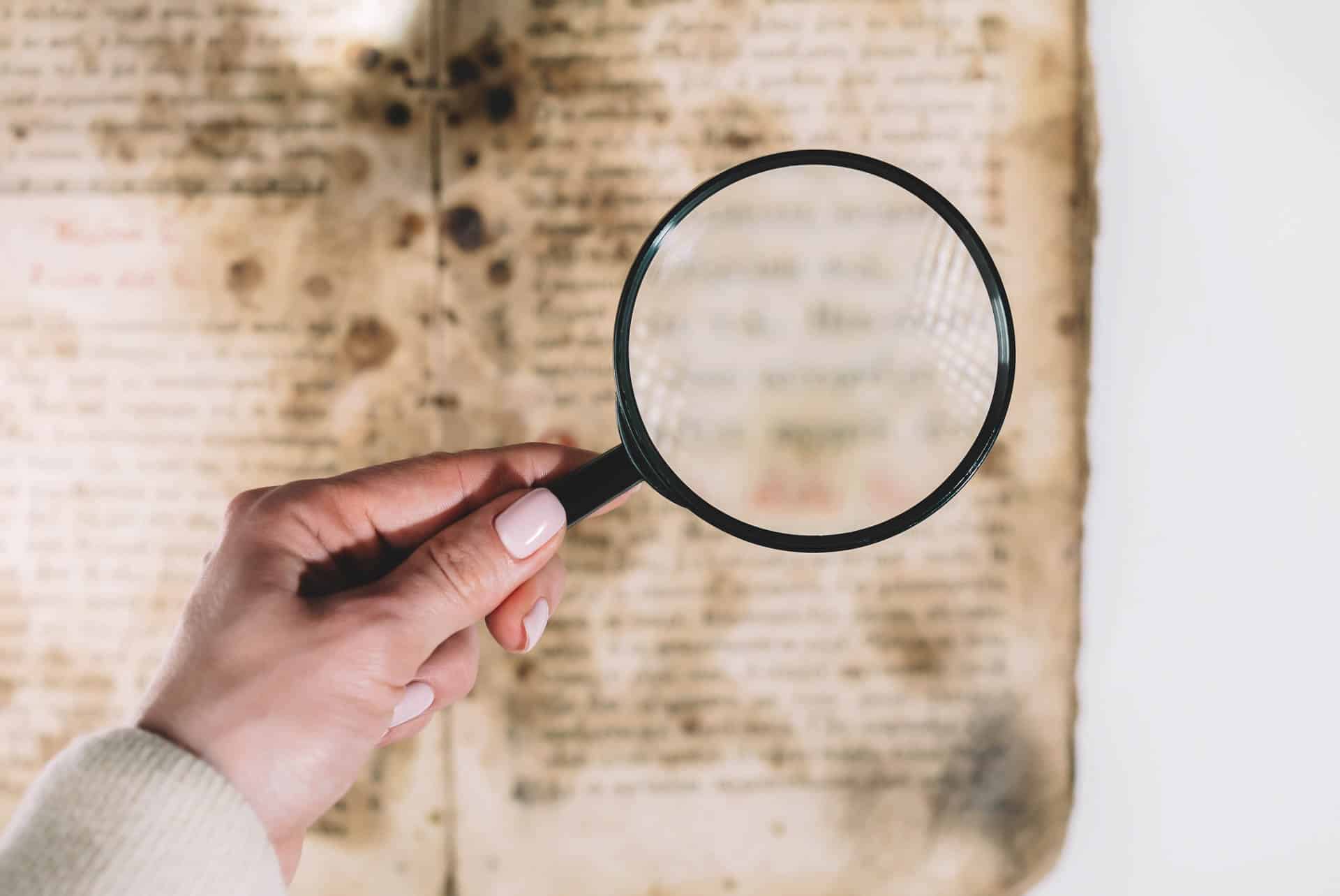 Magnifying Glass looking at an old manuscript
