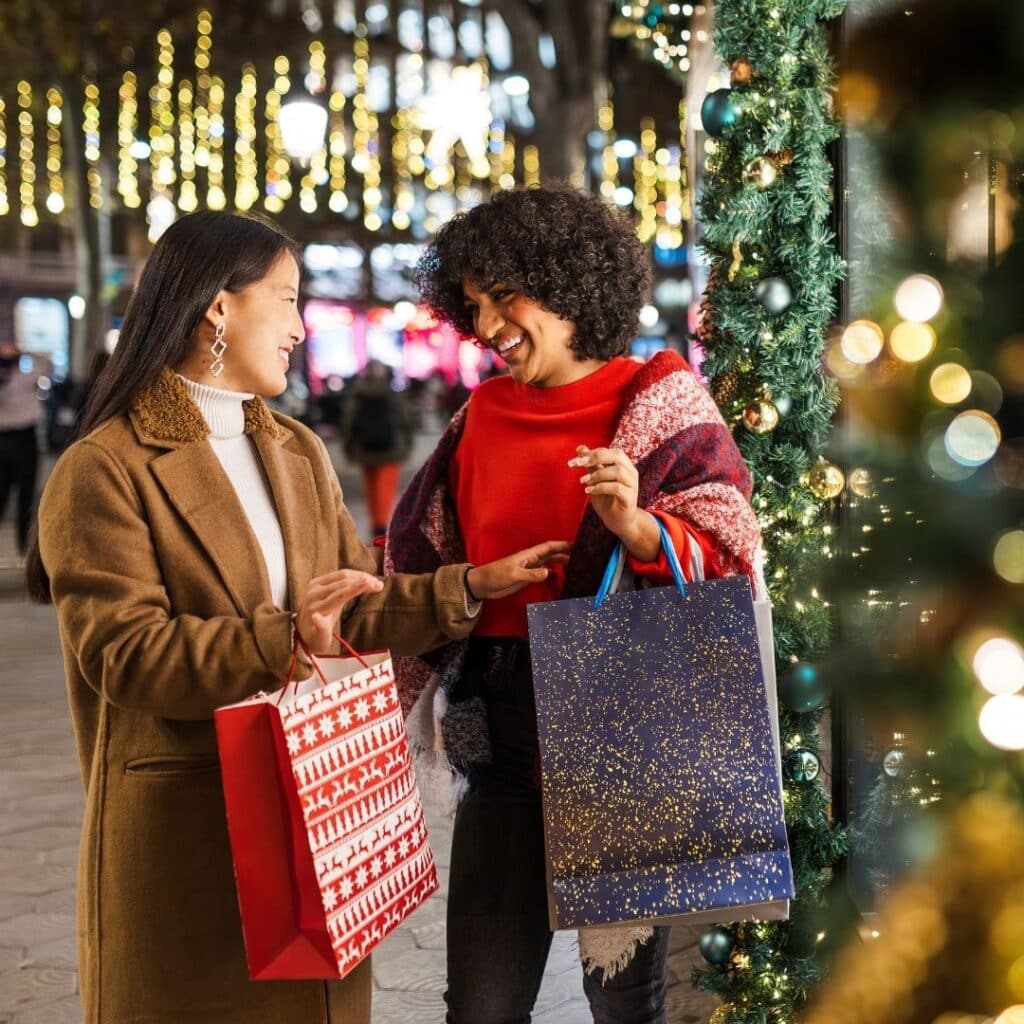 Two girls shopping for Christmas