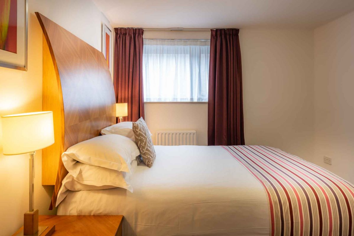 Comfortable bright bedroom at PREMIER SUITES Newcastle