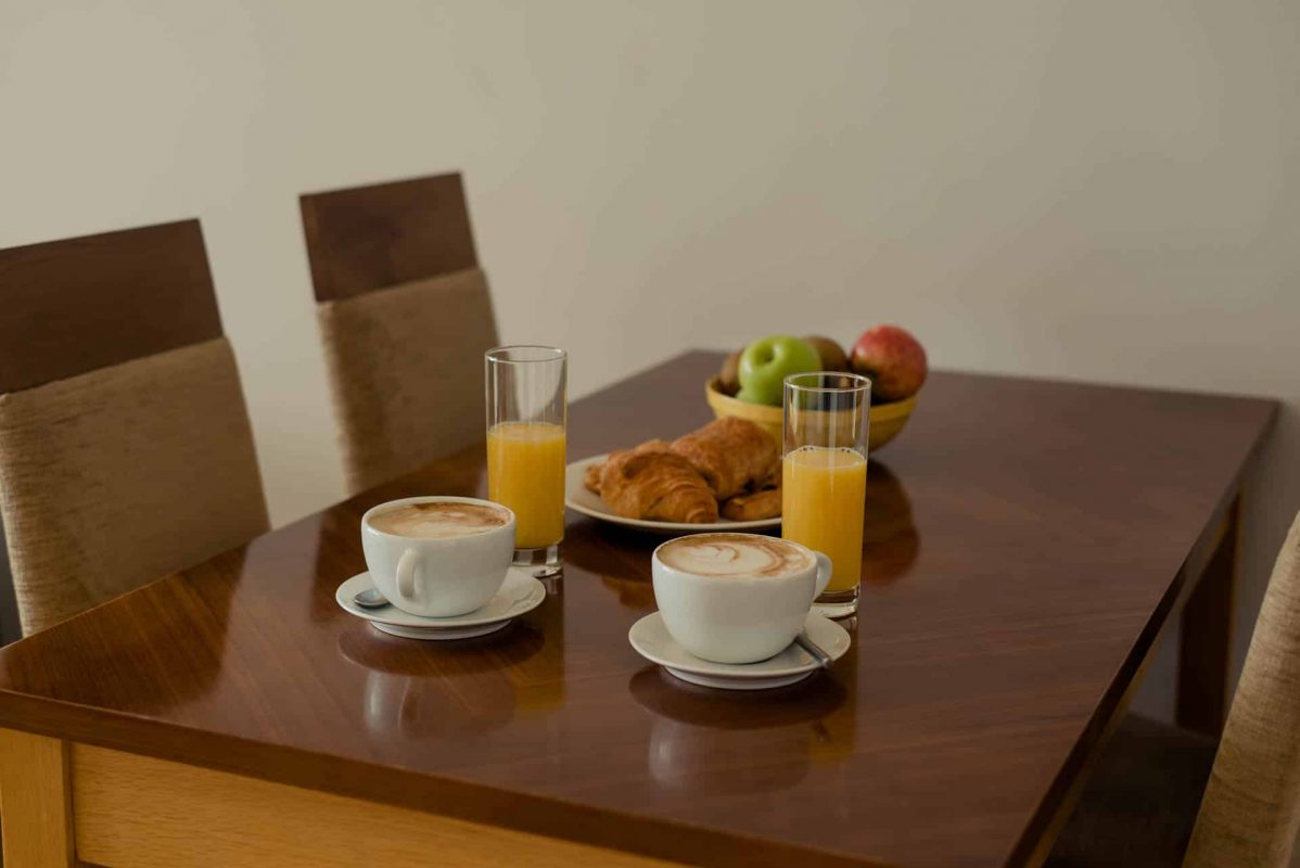 PREMIER SUITES Dublin Sandyford (table and chairs with fruit and food with drinks)
