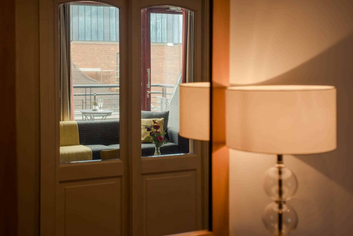 PREMIER SUITES PLUS Dublin Leeson Street lampshade and doors looking out to balcony