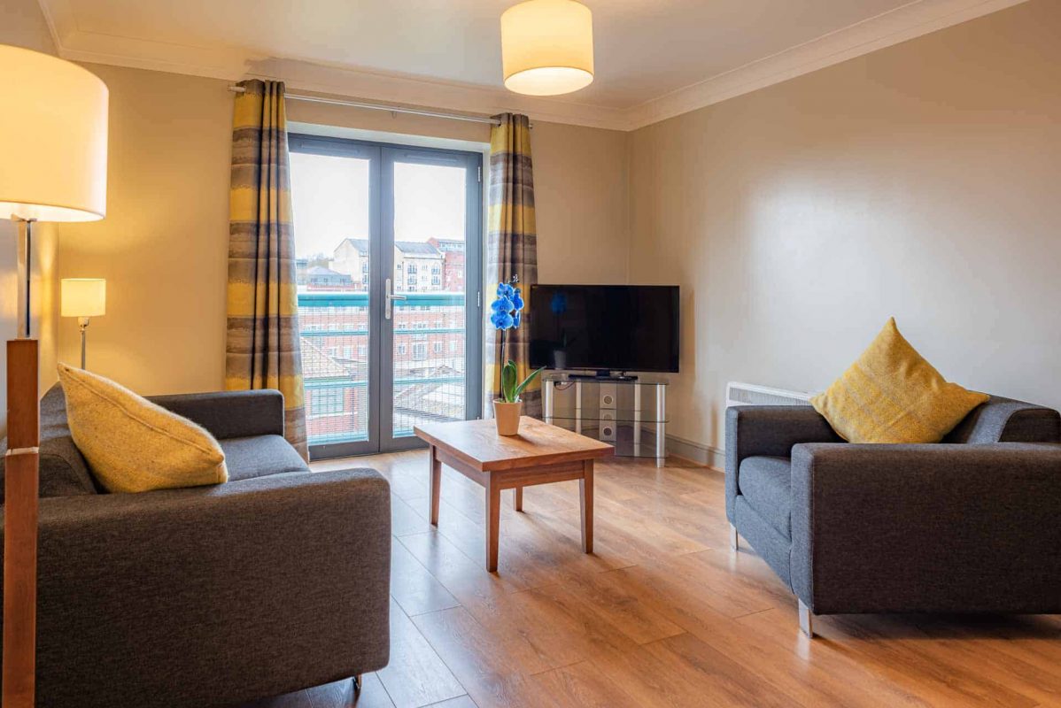 Sitting room with two sofas and TV at PREMIER SUITES Bristol Redcliffe